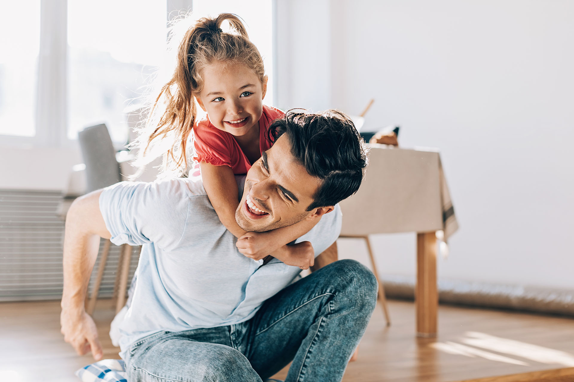 Father playing with his little girl at home